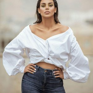 woman in white Neck Long Sleeve Top and jeans.