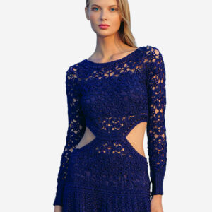 A woman in a Dark Sky Crochet Dress with blue cutouts exudes elegance.